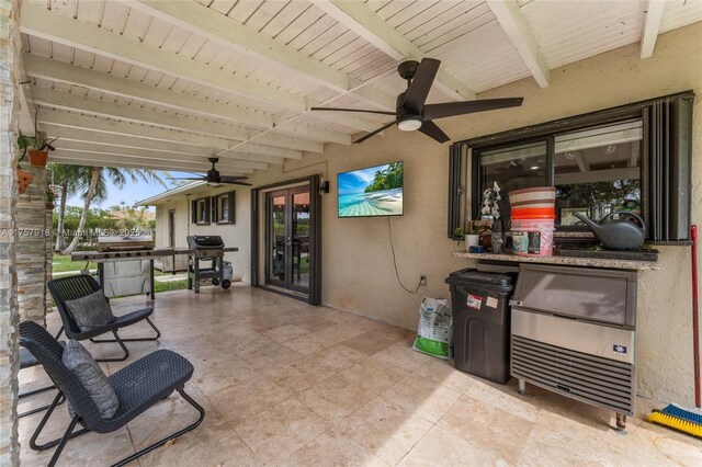 view of patio featuring a ceiling fan and french doors