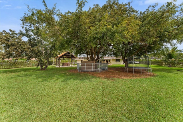 view of yard with a trampoline and a gazebo