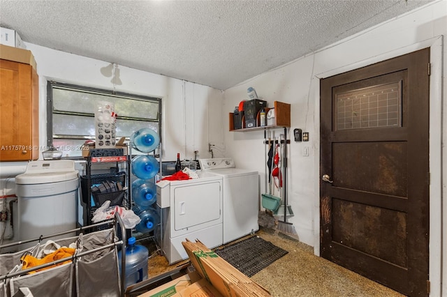 clothes washing area featuring washer and dryer, laundry area, and a textured ceiling