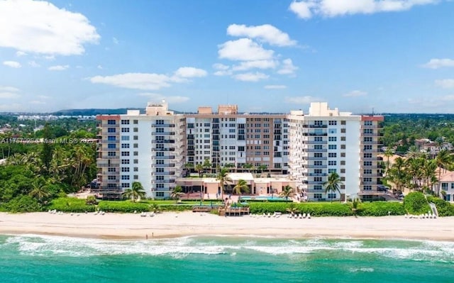 bird's eye view with a water view and a beach view