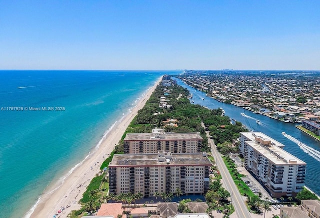 drone / aerial view featuring a view of the beach and a water view