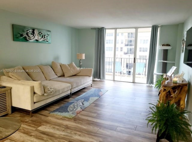 living area with expansive windows and wood finished floors