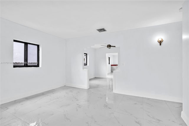 unfurnished room featuring marble finish floor, visible vents, and baseboards