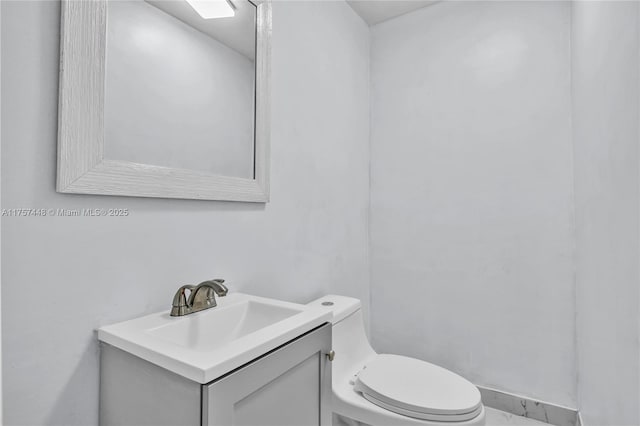 half bathroom with toilet and vanity