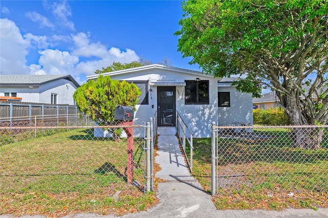 bungalow-style home featuring fence private yard and a front lawn