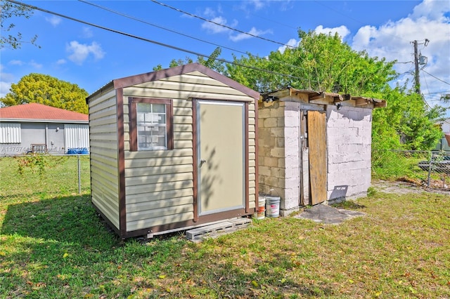 view of shed featuring fence