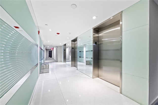 hallway featuring recessed lighting and elevator