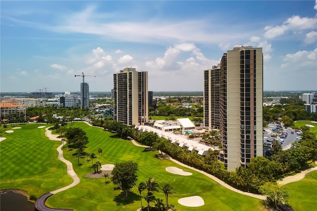 aerial view featuring view of golf course and a city view