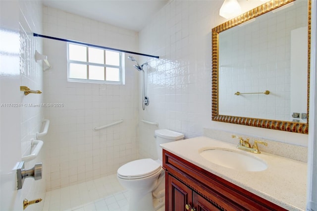 bathroom with tiled shower, tile walls, toilet, and vanity