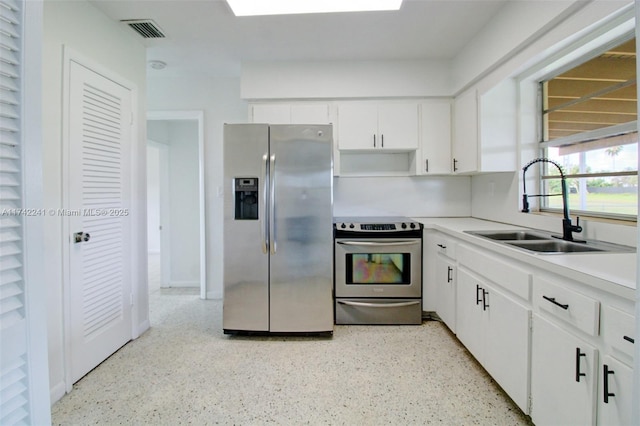 kitchen with visible vents, white cabinets, appliances with stainless steel finishes, light countertops, and a sink