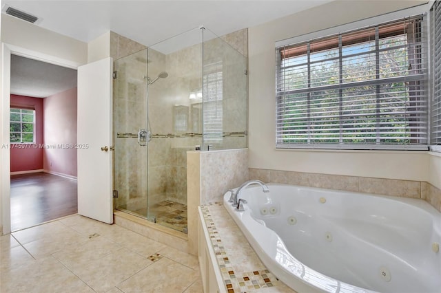 bathroom with a whirlpool tub, tile patterned flooring, visible vents, and a shower stall