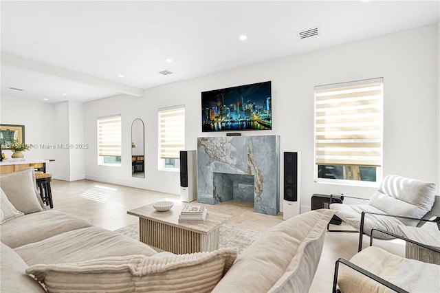 living room with recessed lighting, beam ceiling, visible vents, and a fireplace