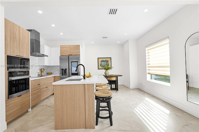 kitchen with visible vents, marble finish floor, appliances with stainless steel finishes, wall chimney exhaust hood, and modern cabinets