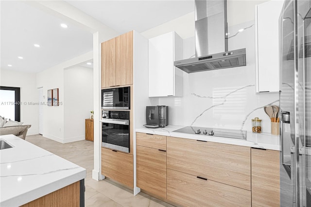 kitchen featuring black electric stovetop, oven, built in microwave, wall chimney exhaust hood, and modern cabinets