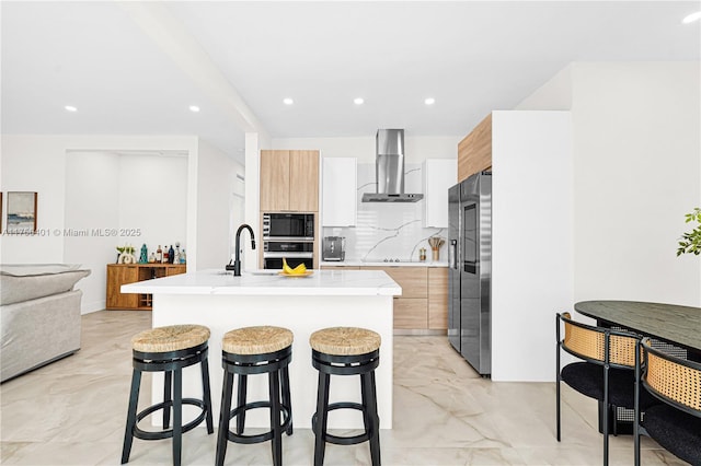 kitchen featuring wall chimney range hood, stainless steel fridge with ice dispenser, modern cabinets, and built in microwave