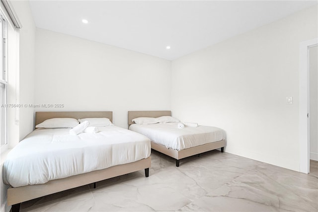 bedroom featuring recessed lighting, marble finish floor, and baseboards