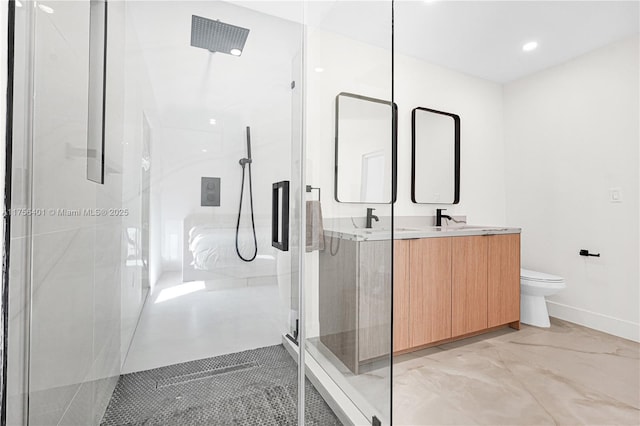 bathroom with double vanity, an enclosed shower, toilet, and baseboards