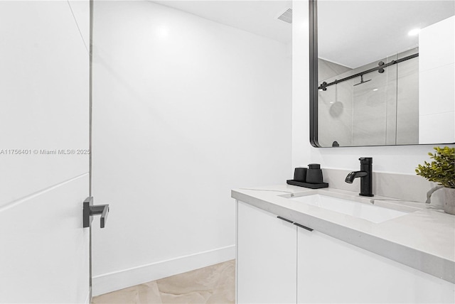 full bath with baseboards, a shower stall, and vanity