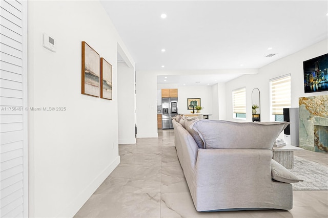 living area with recessed lighting, a fireplace, visible vents, baseboards, and marble finish floor