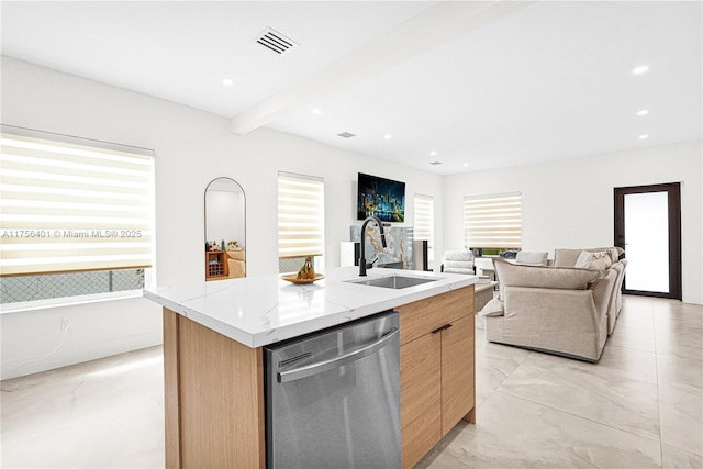 kitchen featuring a sink, visible vents, a healthy amount of sunlight, stainless steel dishwasher, and modern cabinets