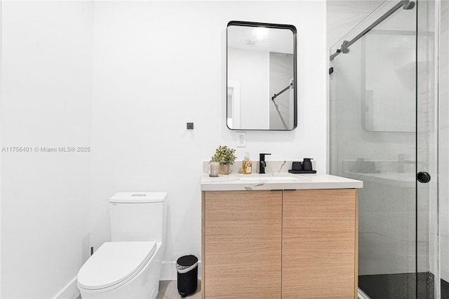 bathroom with toilet, a stall shower, and vanity