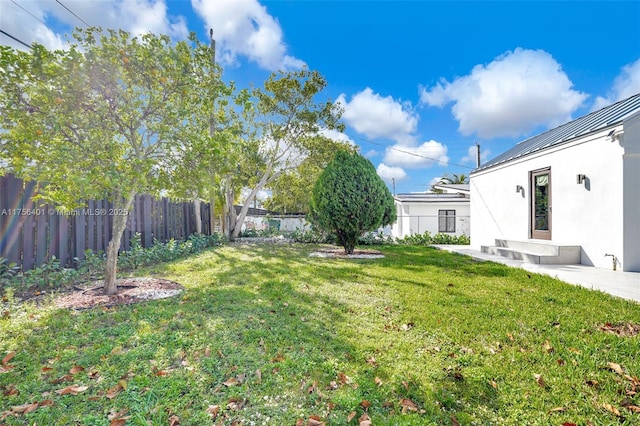 view of yard featuring fence and a patio