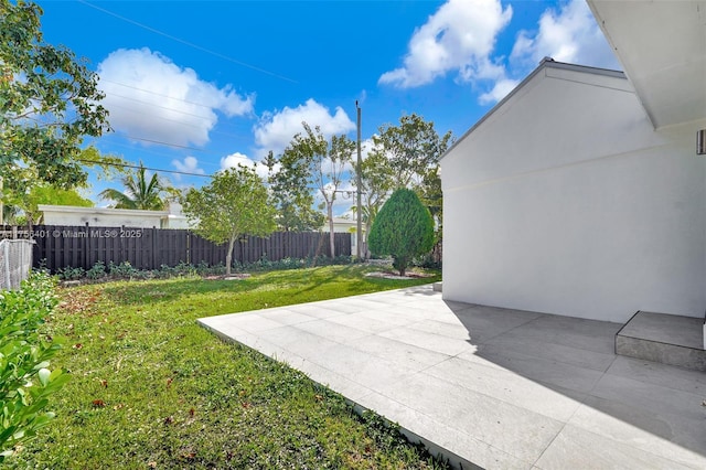 view of yard featuring a patio and fence