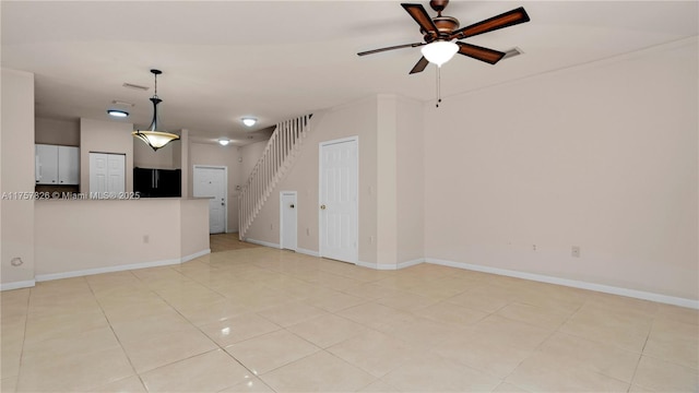 unfurnished living room with light tile patterned flooring, a ceiling fan, visible vents, stairs, and baseboards