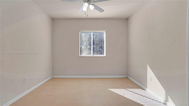 spare room with ceiling fan and baseboards