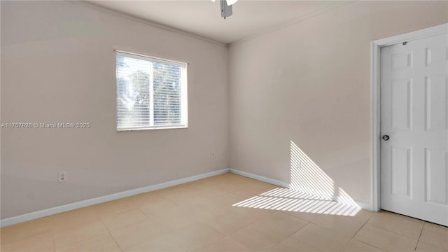 unfurnished room with baseboards, ornamental molding, a ceiling fan, and light tile patterned flooring