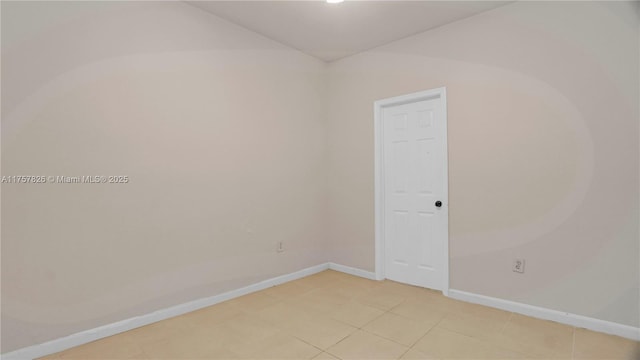 spare room with baseboards