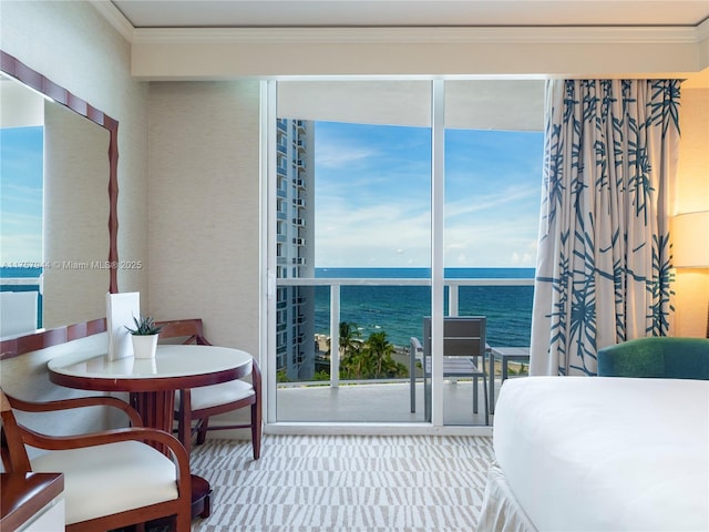 bedroom with carpet, a water view, and crown molding