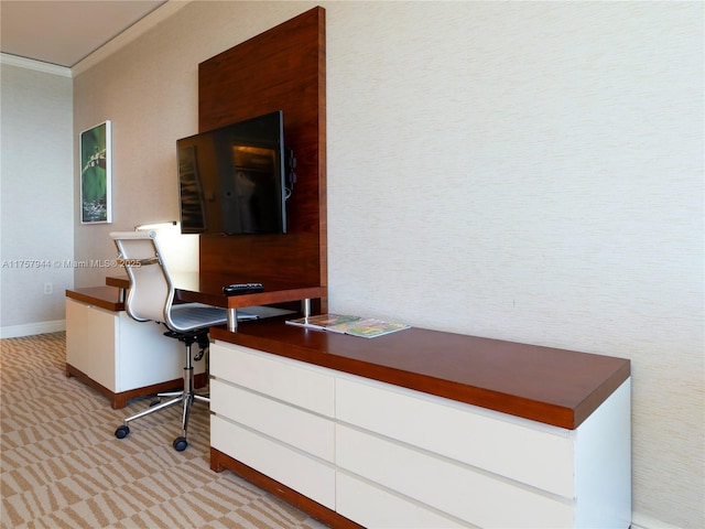 home office with light carpet, baseboards, and crown molding