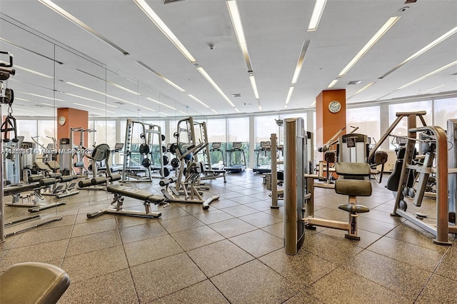 exercise room featuring a wall of windows and visible vents