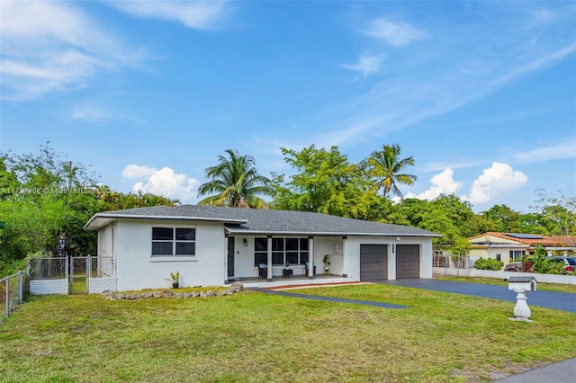 ranch-style home with aphalt driveway, an attached garage, fence, stucco siding, and a front yard