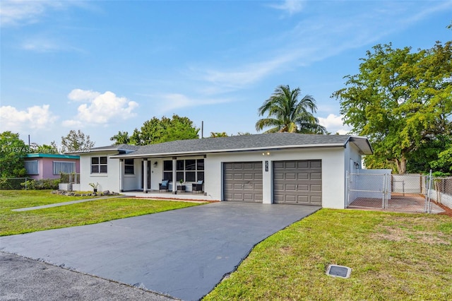 single story home with a garage, fence, a gate, stucco siding, and a front yard