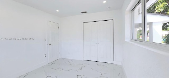 unfurnished bedroom with visible vents, baseboards, marble finish floor, a closet, and recessed lighting