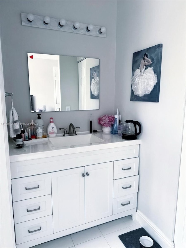 bathroom with tile patterned flooring, vanity, and baseboards