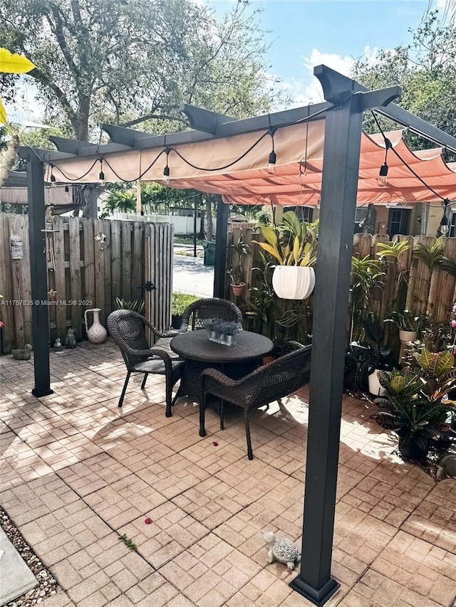 view of patio / terrace with fence and a pergola