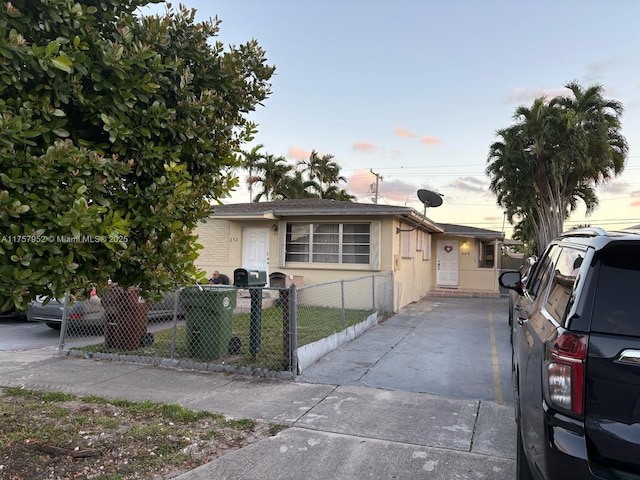 view of front facade with a fenced front yard and stucco siding