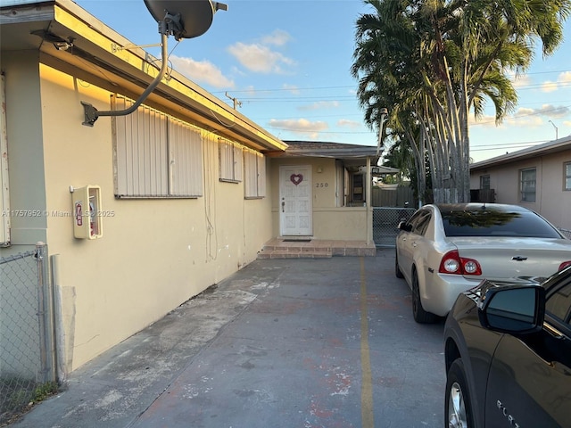 exterior space featuring fence and stucco siding