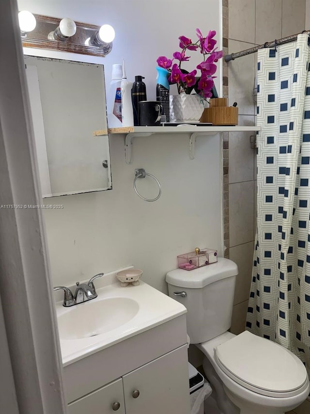 bathroom with toilet, vanity, and a shower with shower curtain