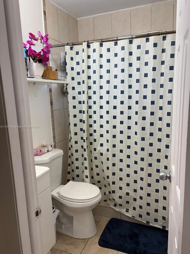 full bathroom with a shower with shower curtain, vanity, toilet, and tile patterned floors