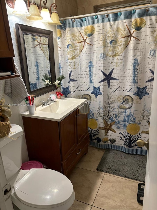 bathroom featuring toilet, a shower with curtain, vanity, and tile patterned floors