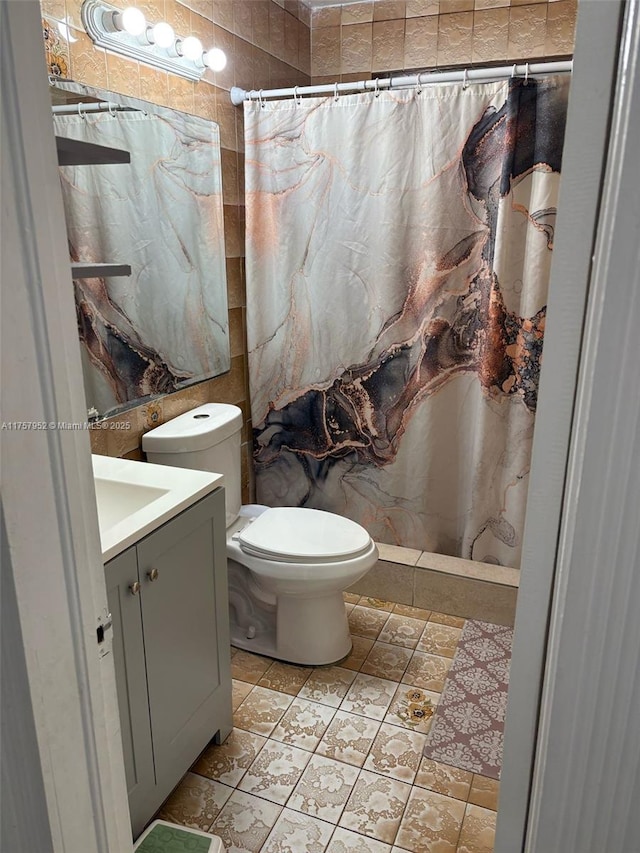 full bath featuring toilet, curtained shower, tile patterned floors, and vanity