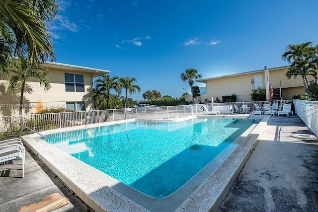 pool with fence and a patio