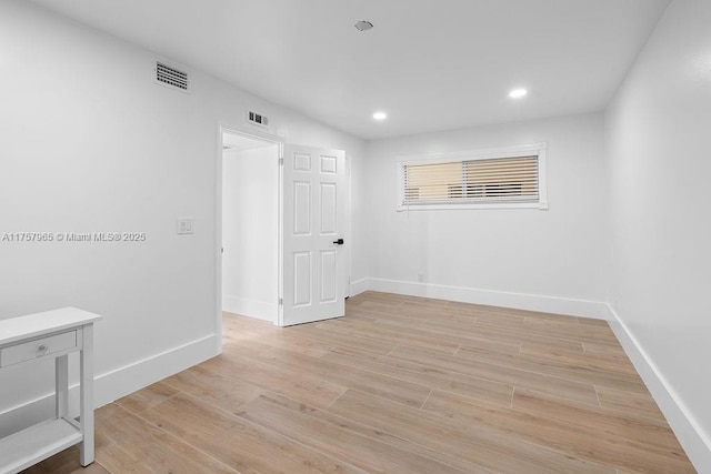 spare room featuring baseboards, recessed lighting, visible vents, and light wood-style floors