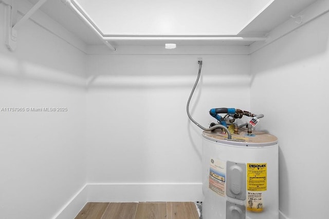 utility room with electric water heater