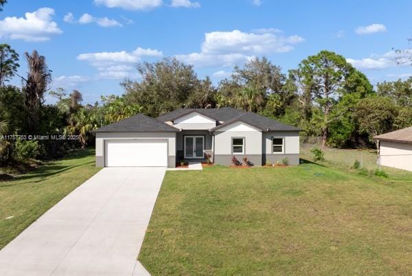 view of front of home with a garage, driveway, a front lawn, and fence