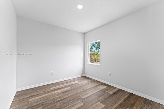 empty room with wood finished floors and baseboards